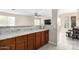 Kitchen breakfast bar with granite countertop and wood cabinets at 17881 W Larkspur Dr, Surprise, AZ 85388