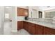 Kitchen breakfast bar with granite countertop and wood cabinets at 17881 W Larkspur Dr, Surprise, AZ 85388