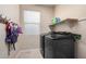 Convenient laundry room with washer, dryer, and shelving at 17881 W Larkspur Dr, Surprise, AZ 85388