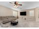 Spacious living room with a large sectional sofa and tile flooring at 17881 W Larkspur Dr, Surprise, AZ 85388