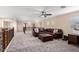 Spacious loft area with leather sectional sofa and built-in workspace at 17881 W Larkspur Dr, Surprise, AZ 85388
