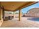 Covered patio with comfortable seating overlooking the pool at 17881 W Larkspur Dr, Surprise, AZ 85388
