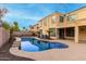 Luxury backyard with a kidney-shaped pool and a two-story house at 17881 W Larkspur Dr, Surprise, AZ 85388