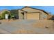 Front view of a house with a two-car garage and desert landscaping at 18758 W Shangri La Rd, Surprise, AZ 85388