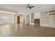 Open concept living room with a fireplace and wood entry door at 2740 W Plum Hollow Dr, Anthem, AZ 85086