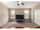 Bright bedroom with carpet, ceiling fan and large TV at 33242 N Jamie Ln, San Tan Valley, AZ 85144