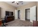 Bedroom with TV and built-in desk and closet at 33242 N Jamie Ln, San Tan Valley, AZ 85144