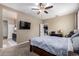 Bright bedroom with a TV and view into kitchen at 33242 N Jamie Ln, San Tan Valley, AZ 85144