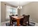 Formal dining room with a wood table and leather chairs at 33242 N Jamie Ln, San Tan Valley, AZ 85144