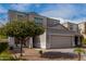 Two-story house with a two-car garage and mature tree in front at 33242 N Jamie Ln, San Tan Valley, AZ 85144