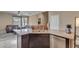 Kitchen island with granite countertop, stainless steel appliances, and dark wood cabinets at 33242 N Jamie Ln, San Tan Valley, AZ 85144