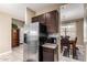 Stainless steel appliances and dark wood cabinets in this kitchen at 33242 N Jamie Ln, San Tan Valley, AZ 85144
