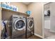 Laundry room with washer, dryer, and shelving at 33242 N Jamie Ln, San Tan Valley, AZ 85144