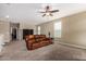Spacious loft with a ceiling fan and plush brown reclining couch at 33242 N Jamie Ln, San Tan Valley, AZ 85144