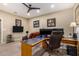 Home office with a large desk, two computer monitors and leather chair at 33242 N Jamie Ln, San Tan Valley, AZ 85144
