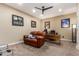 Home office with corner desk, leather recliner, and mounted TV at 33242 N Jamie Ln, San Tan Valley, AZ 85144