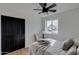 Cozy bedroom with a queen bed, ceiling fan, and black closet doors at 544 E Morrow Dr, Phoenix, AZ 85024