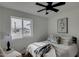 Bright bedroom with a queen bed, ceiling fan, and a view of the street at 544 E Morrow Dr, Phoenix, AZ 85024