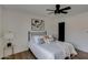 Well-lit bedroom with a queen-size bed, ceiling fan, and artwork at 544 E Morrow Dr, Phoenix, AZ 85024