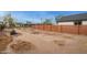 Large backyard with wooden fence and sand at 576 N Pasadena --, Mesa, AZ 85201