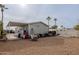 Home's backyard with gravel ground cover and storage items at 625 W Mckellips Rd # 213, Mesa, AZ 85201