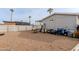 Large gravel backyard with a partial fence and various outdoor items at 625 W Mckellips Rd # 213, Mesa, AZ 85201