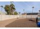 Spacious backyard with gravel, a wooden fence and mature trees at 625 W Mckellips Rd # 213, Mesa, AZ 85201