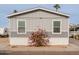 Rear view of gray manufactured home with red flowers at 625 W Mckellips Rd # 213, Mesa, AZ 85201