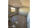 Spacious bedroom with wood-look flooring and large window at 652 S Ellsworth Rd # 170, Mesa, AZ 85208