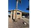 Tan single-wide manufactured home with carport and palm tree at 652 S Ellsworth Rd # 170, Mesa, AZ 85208