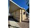 View of the home's exterior, showcasing the carport and walkway at 652 S Ellsworth Rd # 170, Mesa, AZ 85208