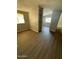 Open living room with wood-look floors and built-in shelving at 652 S Ellsworth Rd # 170, Mesa, AZ 85208
