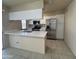 Modern kitchen with white cabinets, stainless steel appliances, and a kitchen island at 7336 W Cheryl Dr, Peoria, AZ 85345