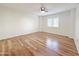 Bright bedroom with wood-look flooring, plantation shutters, and white walls at 10330 W Thunderbird Blvd # A137, Sun City, AZ 85351