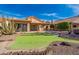 View of the home's backyard, showcasing a putting green at 10633 E Michigan Ave, Sun Lakes, AZ 85248