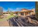 View of home from the backyard; putting green is visible at 10633 E Michigan Ave, Sun Lakes, AZ 85248