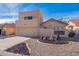 Tan two-story home with a two-car garage and landscaped front yard at 10633 E Michigan Ave, Sun Lakes, AZ 85248