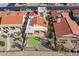 Aerial view of house with red tile roof and putting green in the backyard at 10633 E Michigan Ave, Sun Lakes, AZ 85248