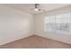 Spacious bedroom featuring a window with blinds and carpeted floors at 14862 W Laurel Ln, Surprise, AZ 85379