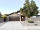 Front view of house with brown garage door and gate at 1520 W Jacinto Ave, Mesa, AZ 85202