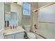 Bathroom with gold fixtures, shower/tub combo, and window at 1550 E Redfield Rd, Phoenix, AZ 85022