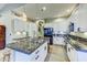 Modern kitchen featuring white cabinets, granite countertops, and stainless steel appliances at 1550 E Redfield Rd, Phoenix, AZ 85022