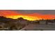 Scenic neighborhood view with a vibrant sunset over the mountains at 1550 E Redfield Rd, Phoenix, AZ 85022