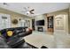 Living room with a stone fireplace, built-in shelving, and a large TV at 1616 W Sierra Sunset Trl, Phoenix, AZ 85085