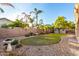 Landscaped backyard with grass, gravel, and shed at 17769 W Alexandria Way, Surprise, AZ 85388