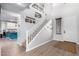 Entryway with stairs, wood-look floors, and view into kitchen at 17769 W Alexandria Way, Surprise, AZ 85388
