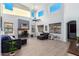 Spacious living room with high ceilings, fireplace, and large windows at 17769 W Alexandria Way, Surprise, AZ 85388