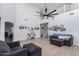 Two-story living room with high ceilings, fireplace, and large windows at 17769 W Alexandria Way, Surprise, AZ 85388