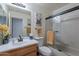 Clean bathroom with a tub shower combo and wood vanity at 24612 S Starcrest Dr, Sun Lakes, AZ 85248