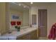 Well-appointed bathroom with single vanity and red accents at 3110 Arroyo Hondo --, Carefree, AZ 85377